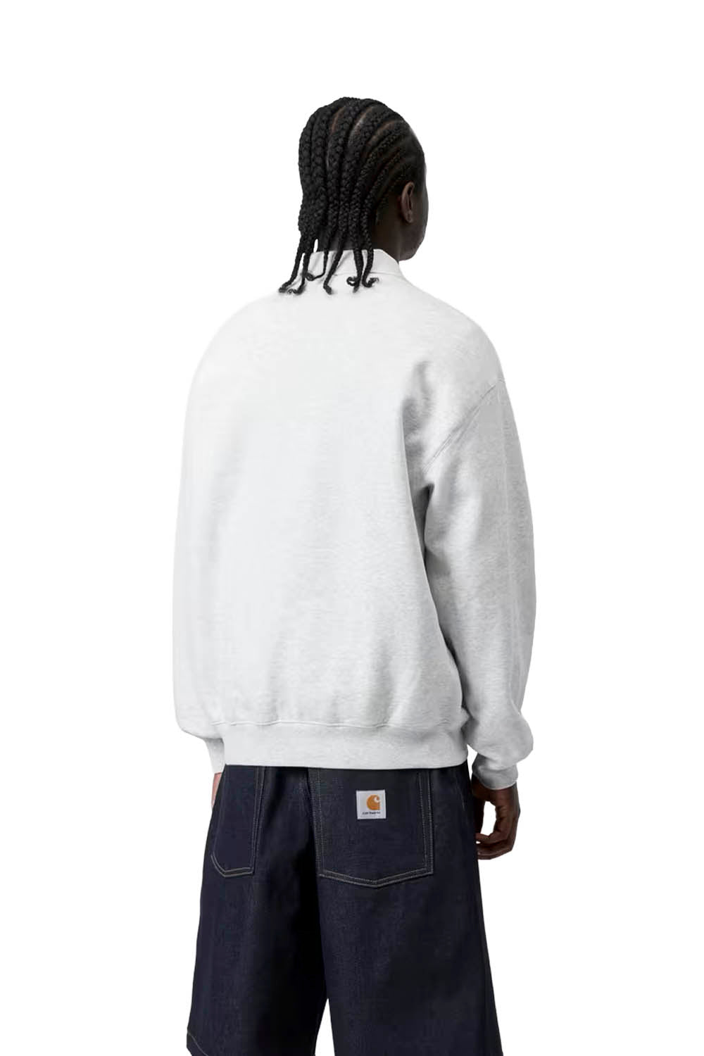 Person wearing a white sweatshirt with a visible brand logo on a white background