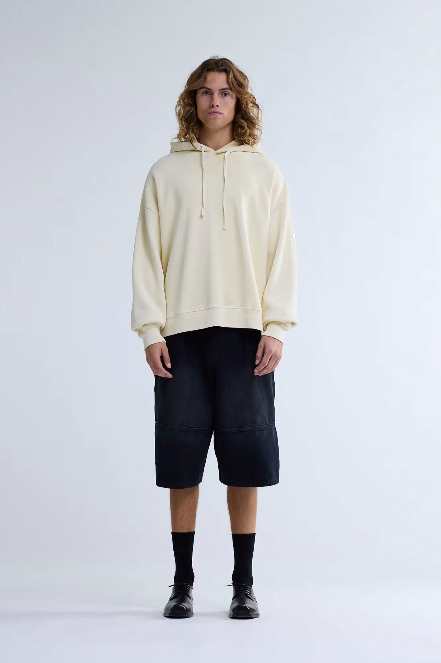 NEW AMSTERDAM SURF ASSOCIATION PLATE HOODIE - Back view showing butter yellow sun-faded finish and oversized fit