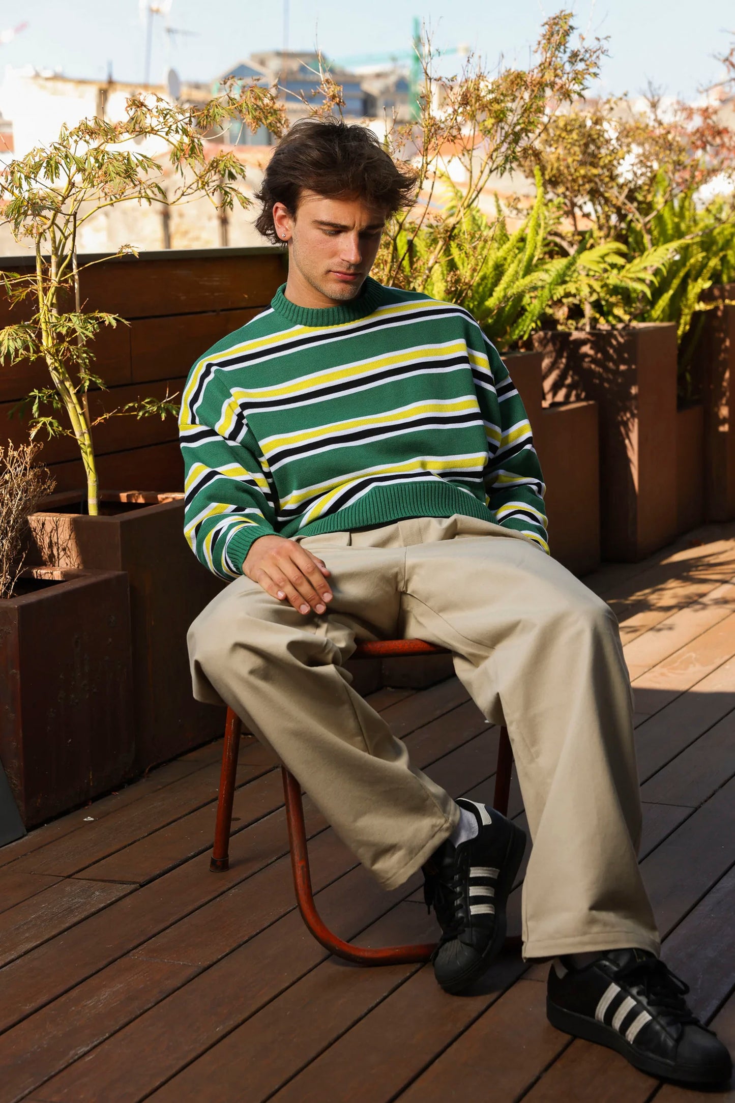 Man sitting on a chair with Nowhere striped sweater Pukas Surf Shop