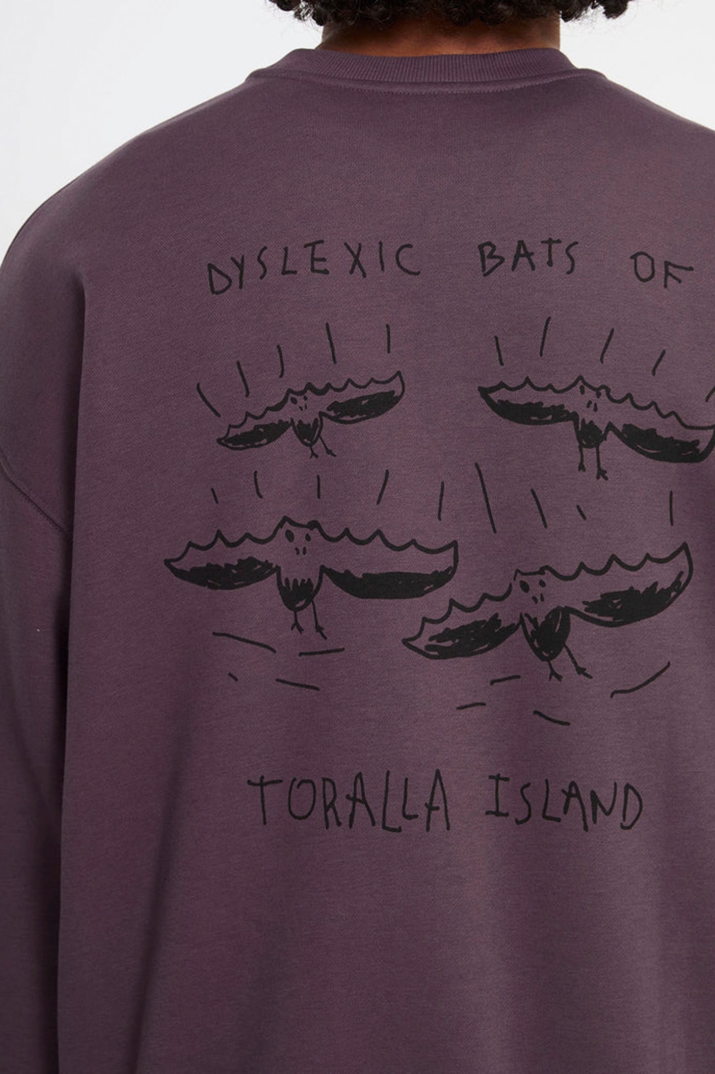 Purple sweatshirt with tGony Zubizarreta's  artwork on the back