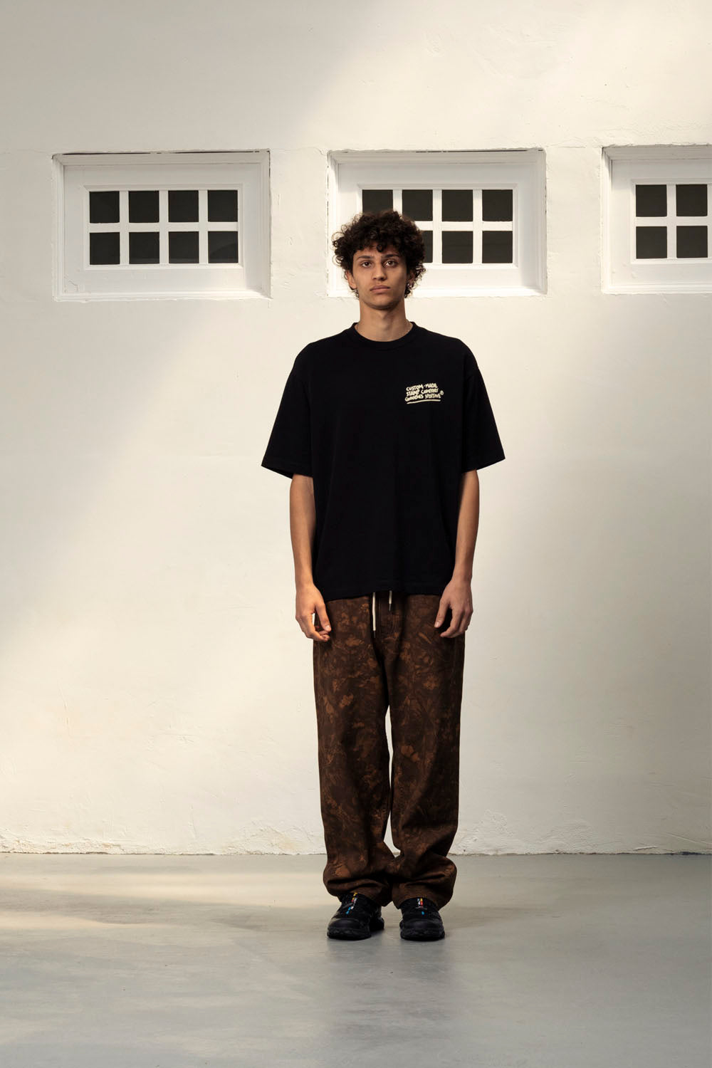 Goodies Sportive Stamp Company Tee in Black - Men's Oversized Graphic T-Shirt at Pukas Surf Shop

