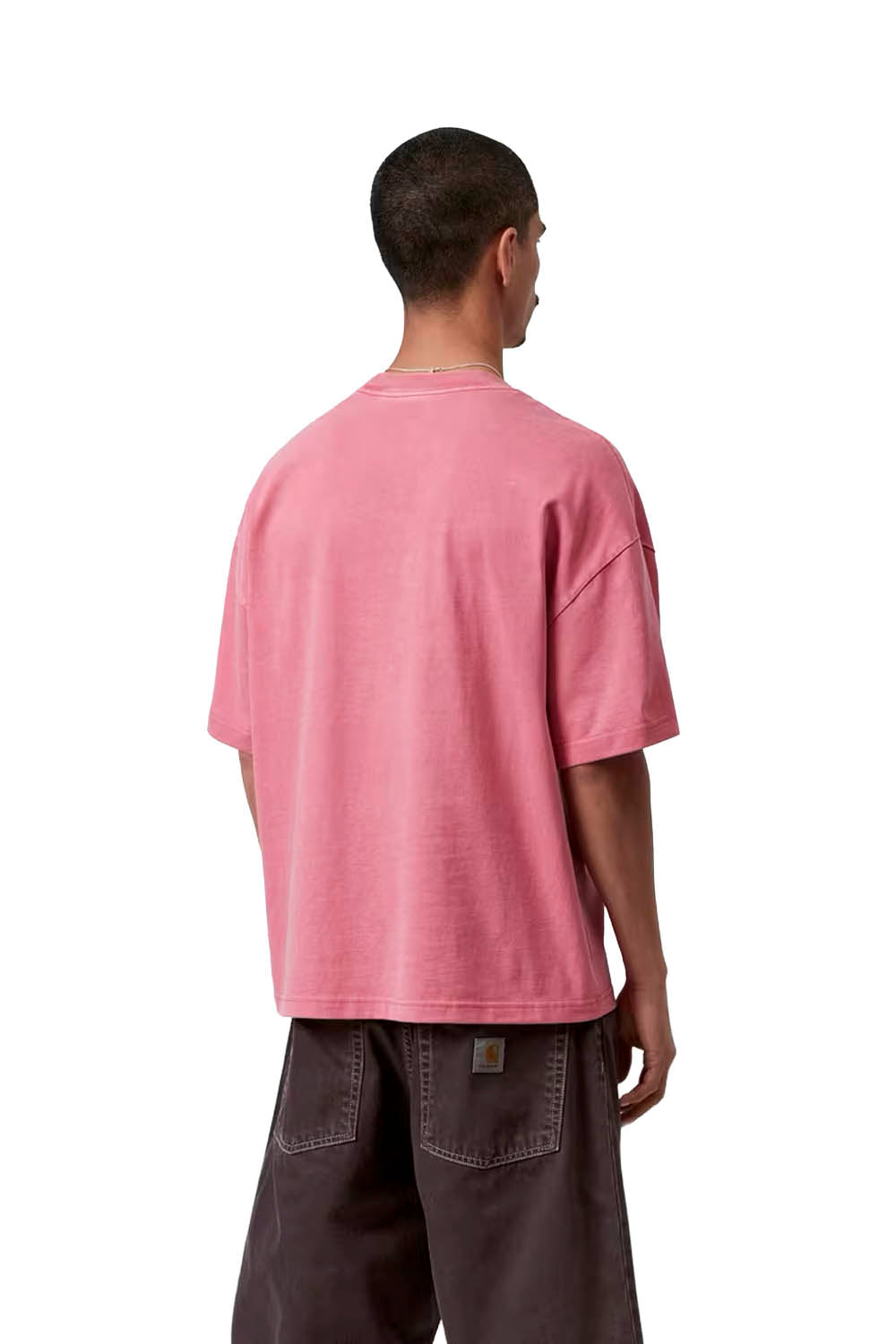 Person wearing a pink t-shirt and dark pants on a white background