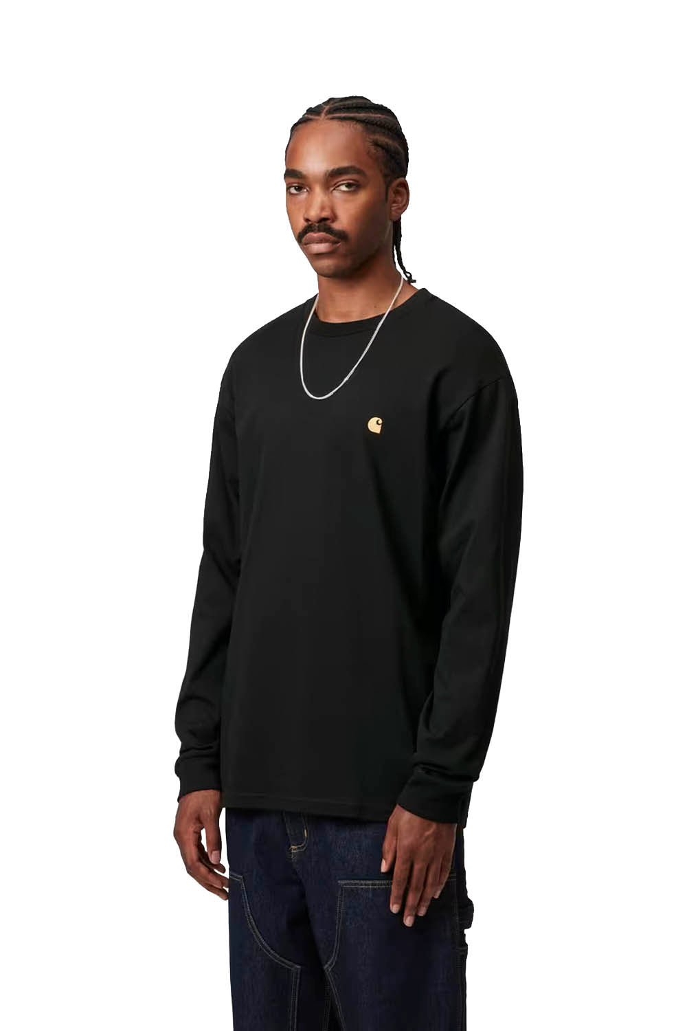 Man wearing a black long-sleeve shirt with a gold logo on a white background