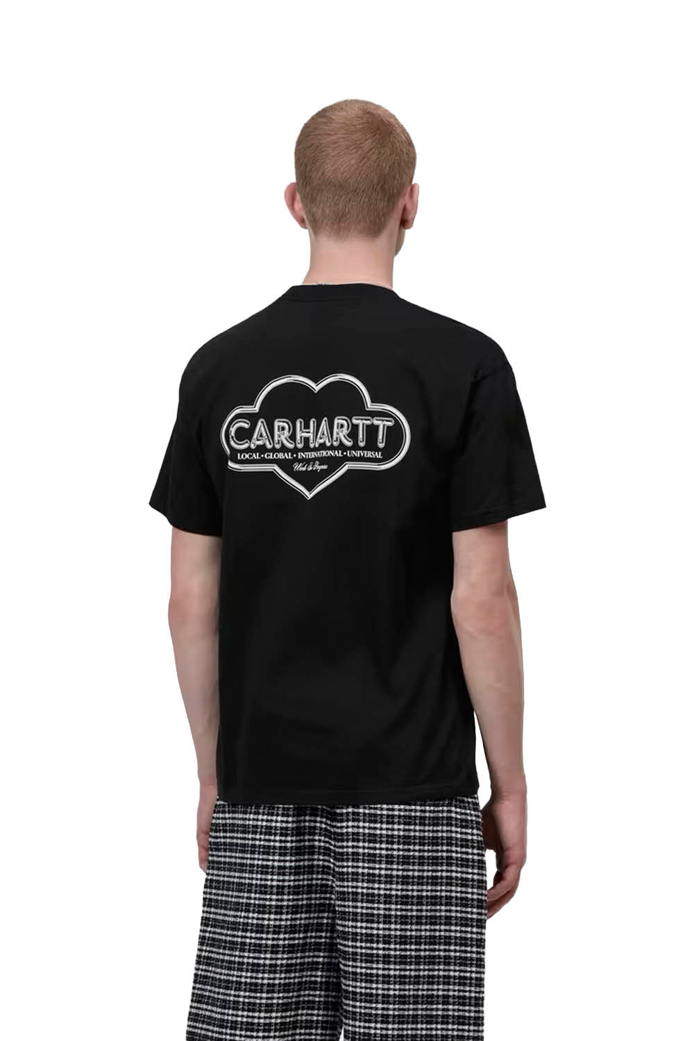 Person wearing a black Carhartt t-shirt with a logo on the back, standing against a white background.