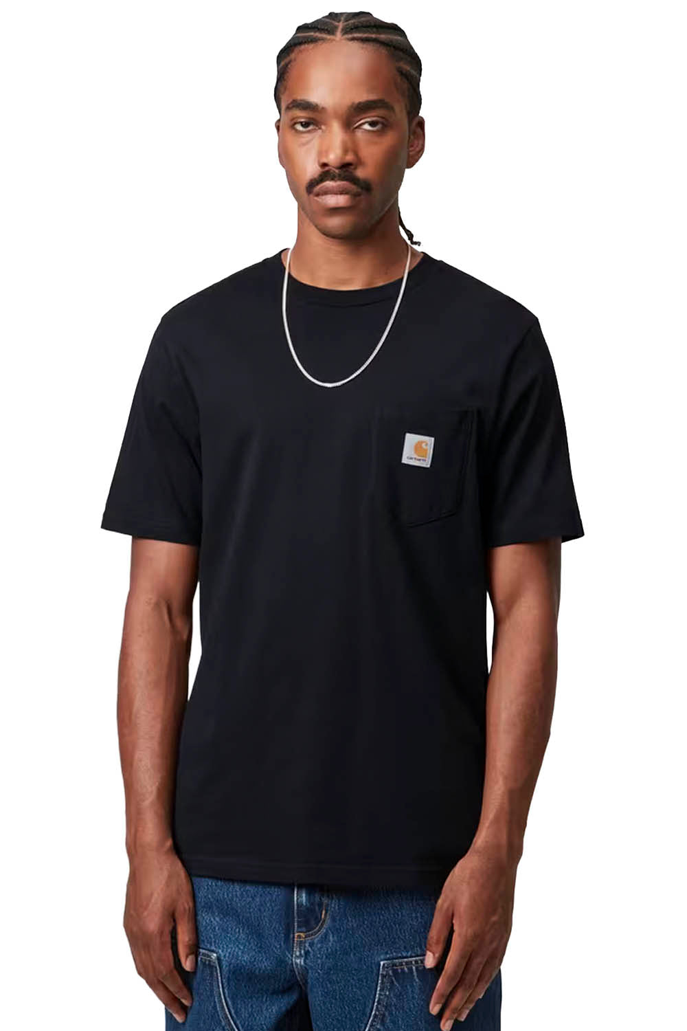 Man wearing a dark navy t-shirt with a Carhartt logo on a white background
