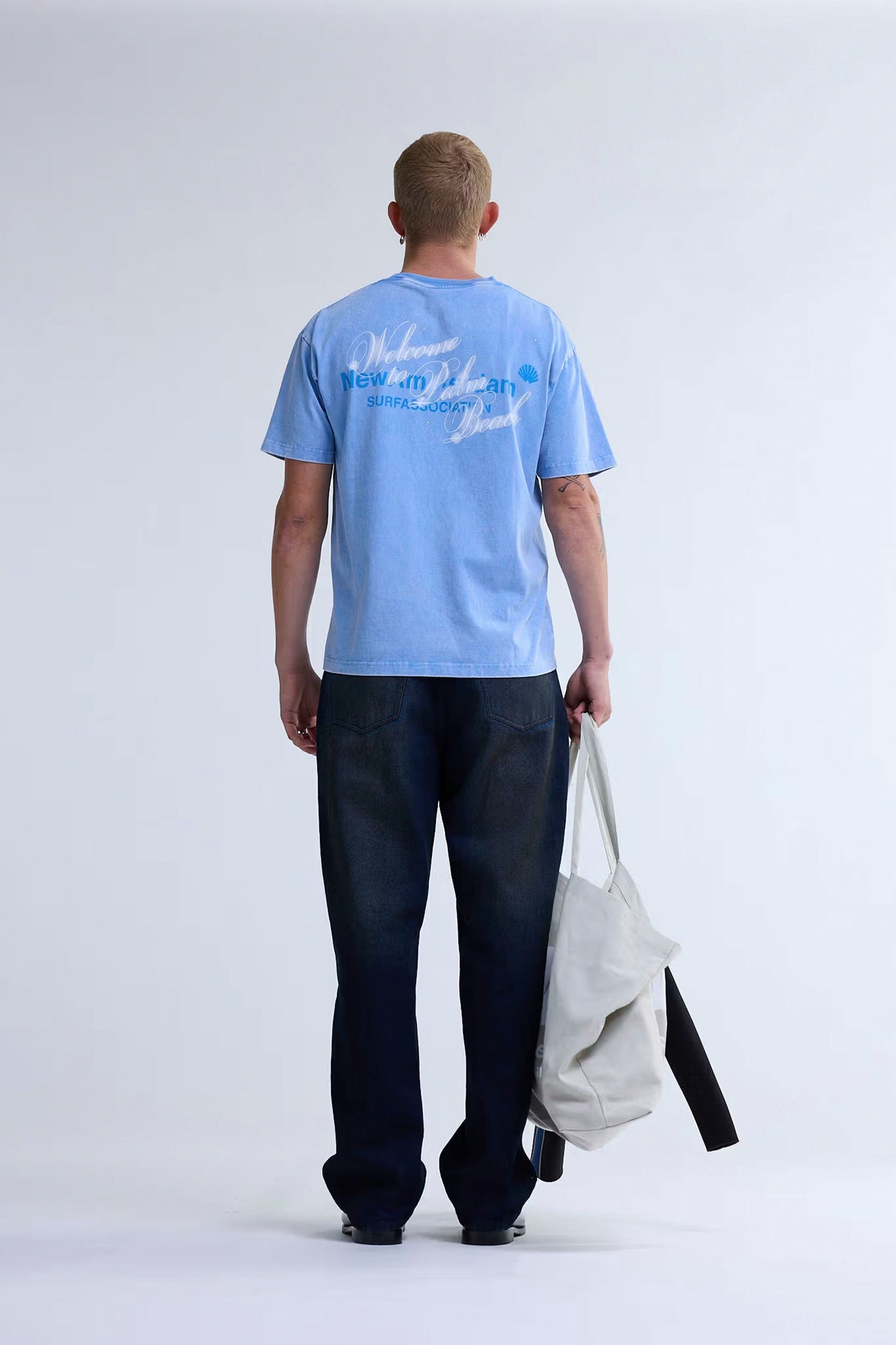 New Amsterdam Surf Association Welcome to Palmbeach blue tee back view showing screenprinted graphics and strass details
