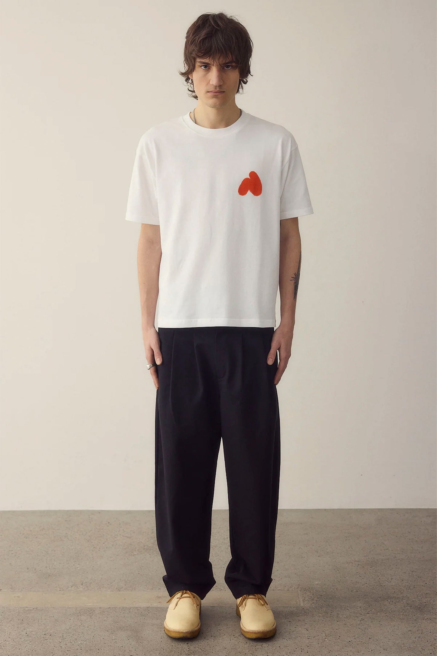 Man wearing white NWHR tee in plain background