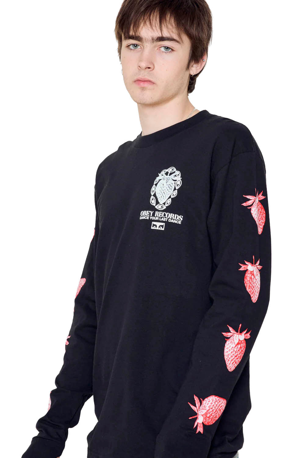 Person wearing a black long-sleeve shirt with red strawberry designs on a white background