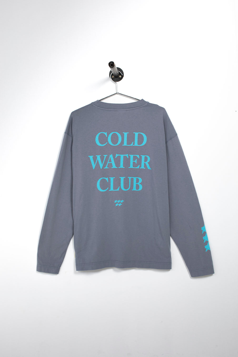 A gray long-sleeve t-shirt hanging on a metal hanger against a white wall. The back of the shirt features the text 'COLD WATER CLUB' printed in a light blue sans-serif font, with a small matching logo underneath and three light blue stripes on the left sleeve.