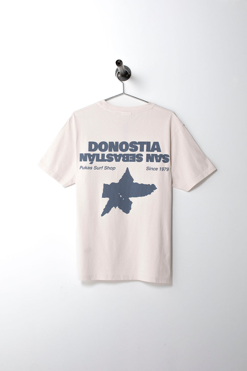 Beige t-shirt with blue graphic and text on a white background