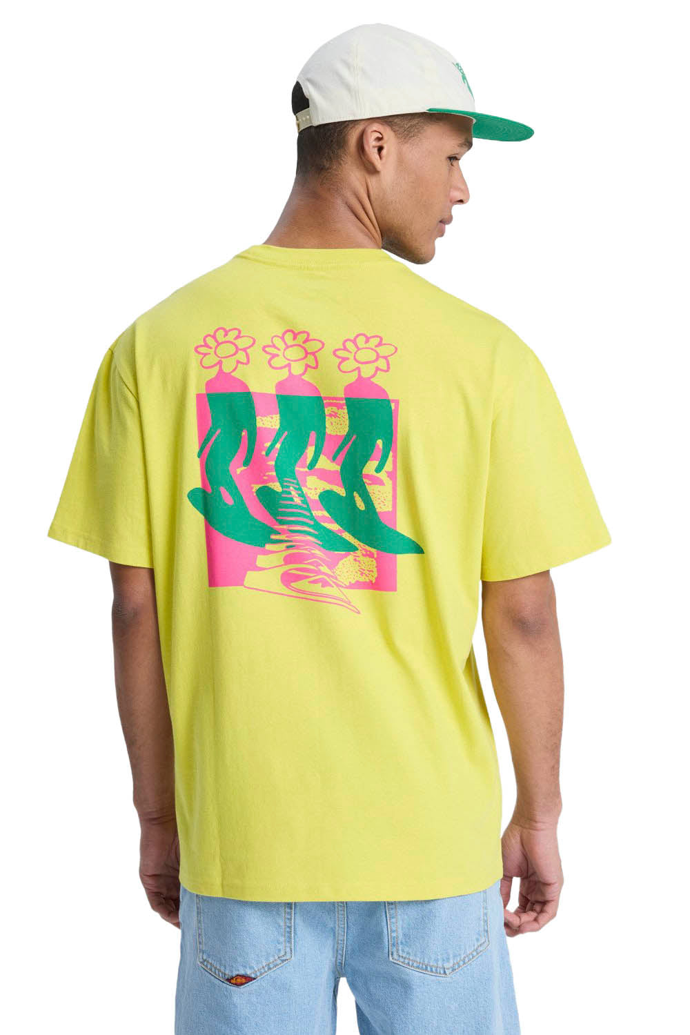 Person wearing a yellow t-shirt with a colorful graphic on the back, standing against a white background.