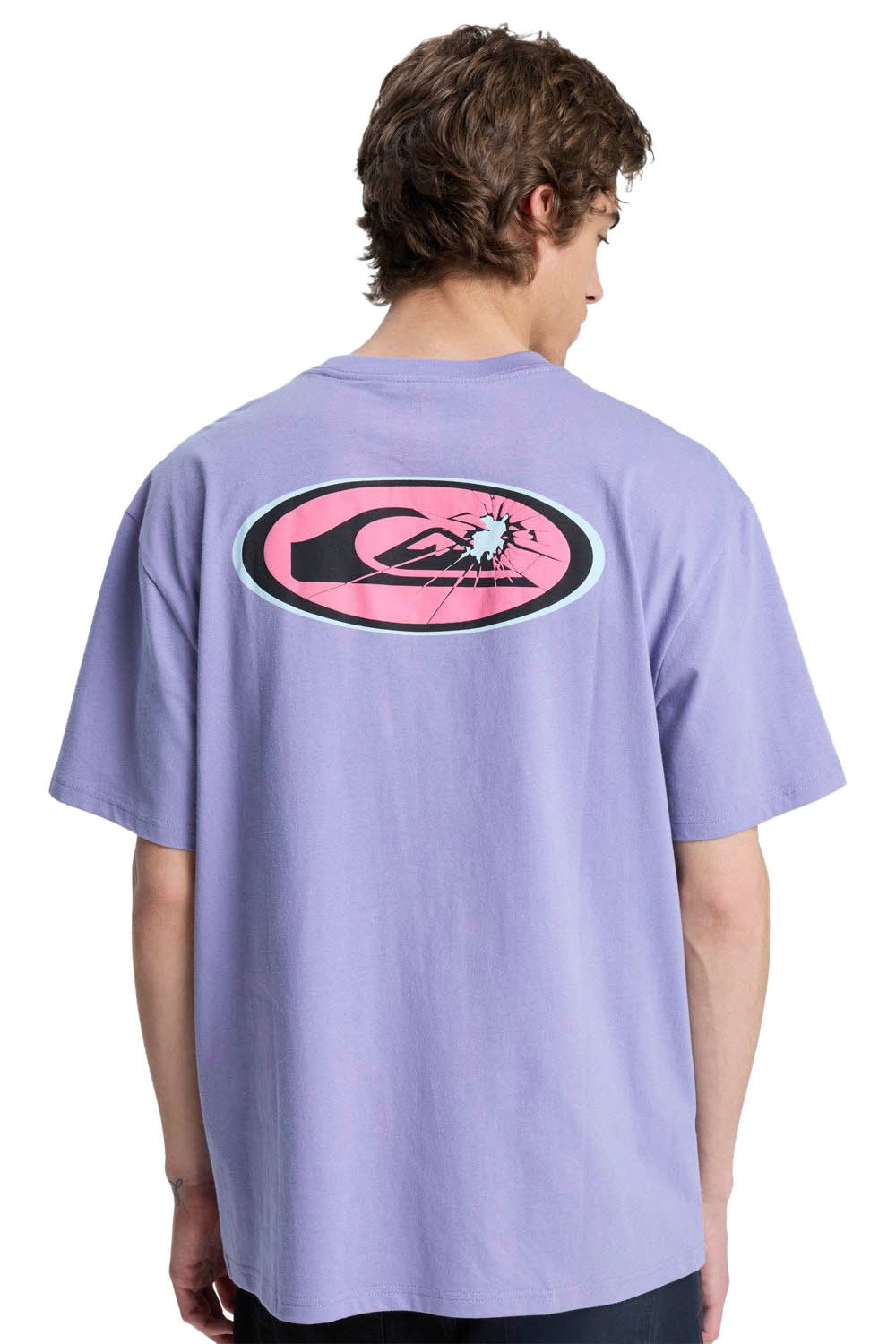 Person wearing a light purple t-shirt with a logo on the back, standing against a white background