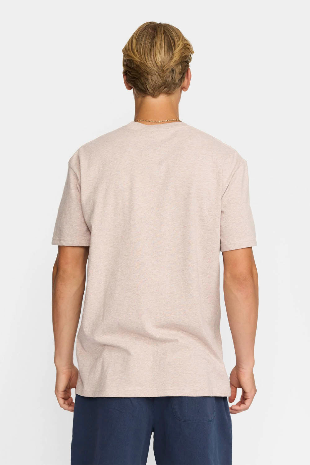 Person wearing a beige t-shirt on a white background