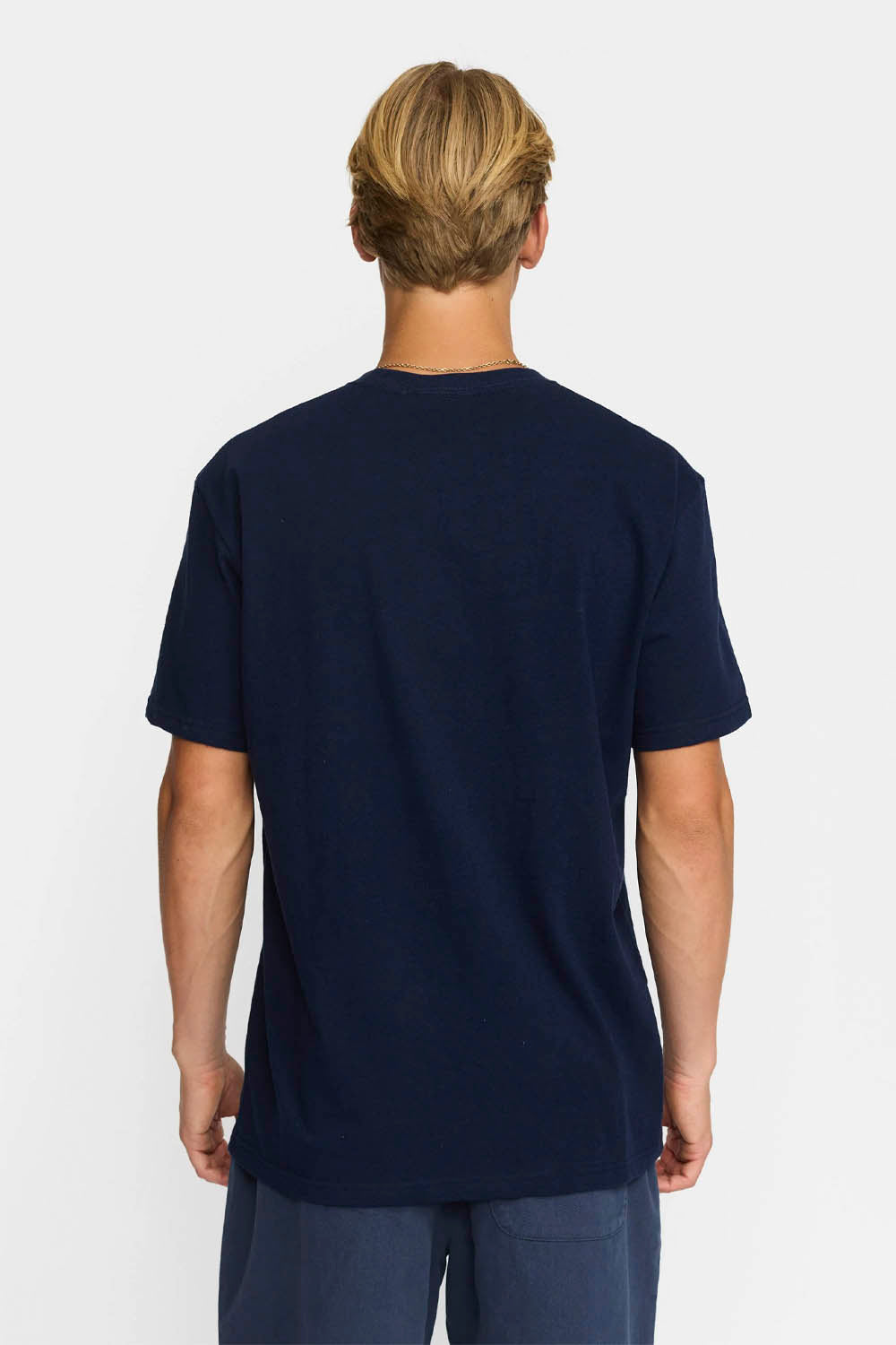 Person wearing a navy blue t-shirt on a white background