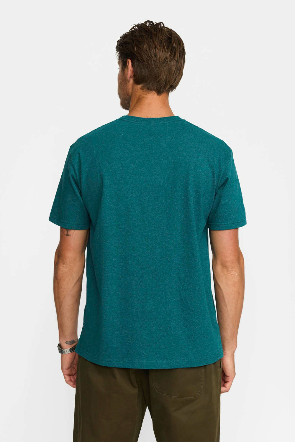 Man wearing a teal t-shirt on a white background