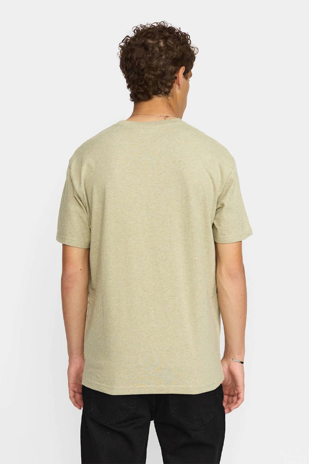 Person wearing a light green t-shirt on a white background