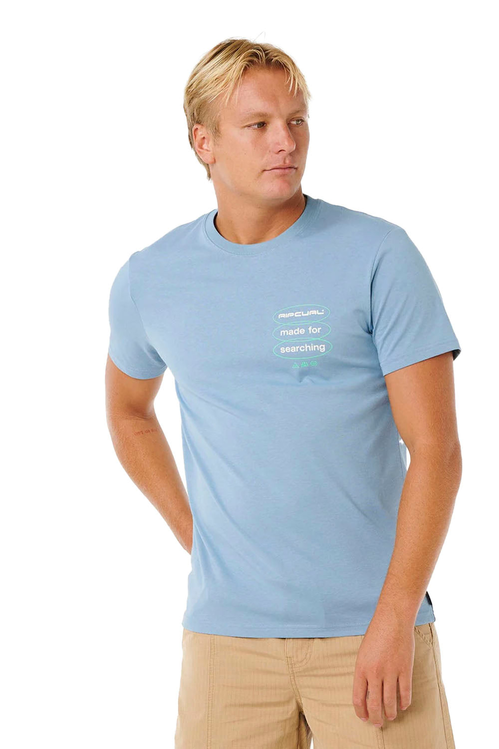 Man wearing a light blue t-shirt with text on a white background