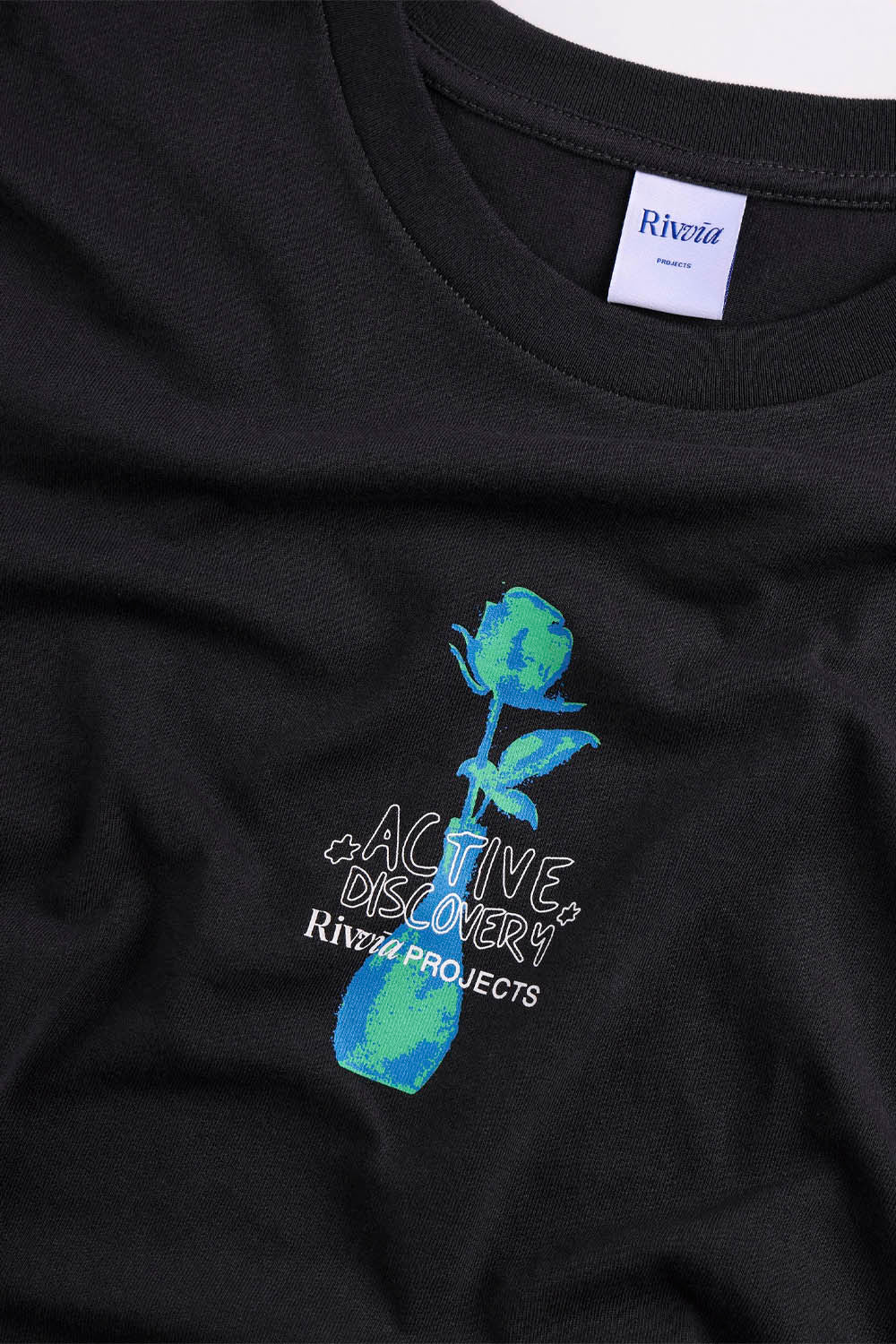 Black t-shirt with a blue rose design and 'Riviera Projects' text on a white background