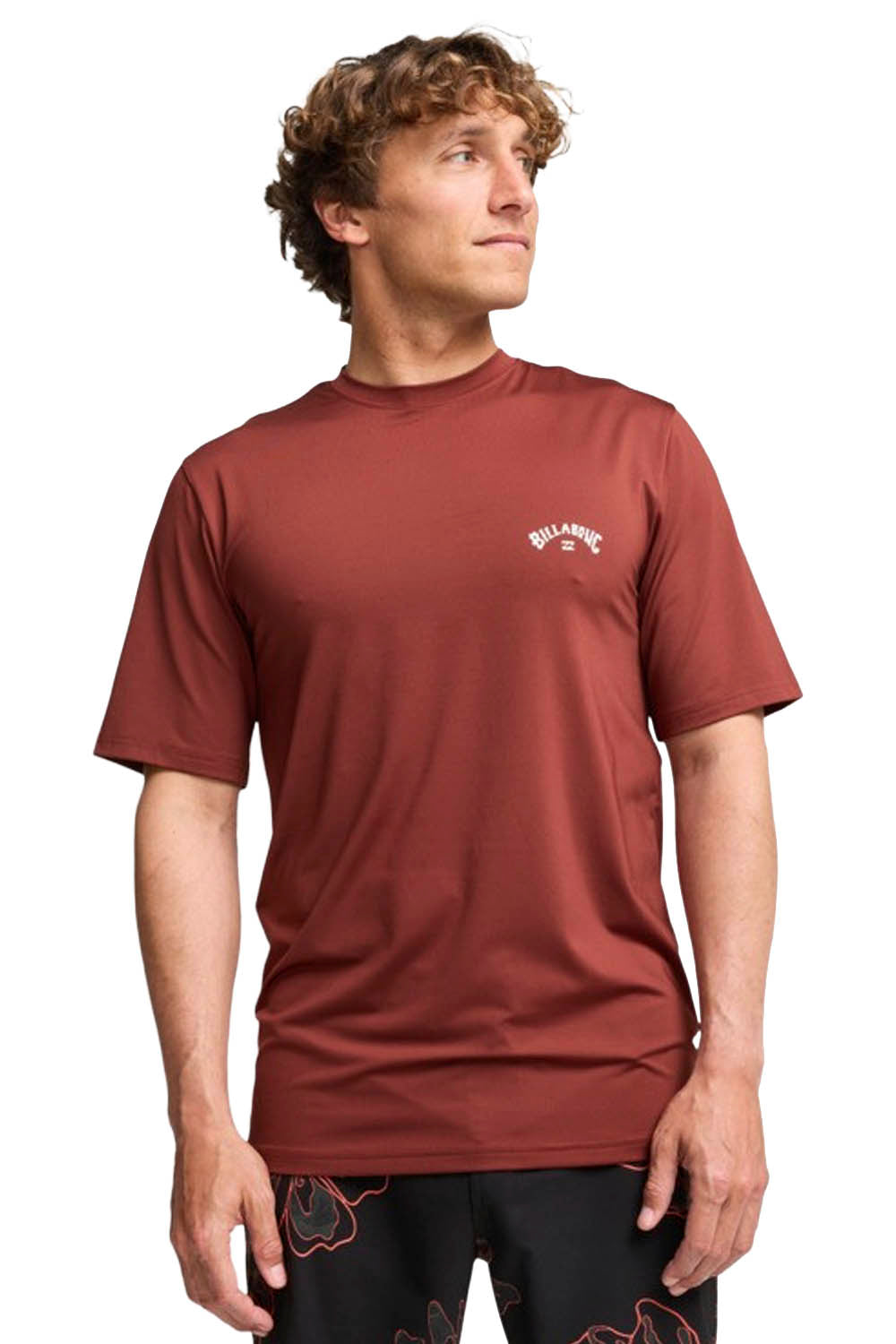Man wearing a maroon t-shirt with a logo on a white background