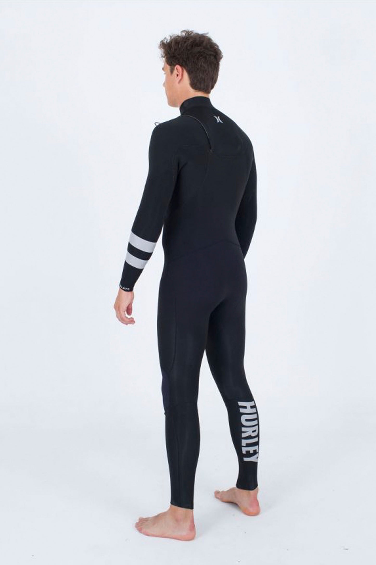 Person wearing a black Hurley Advant 3/2mm wetsuit on a white background