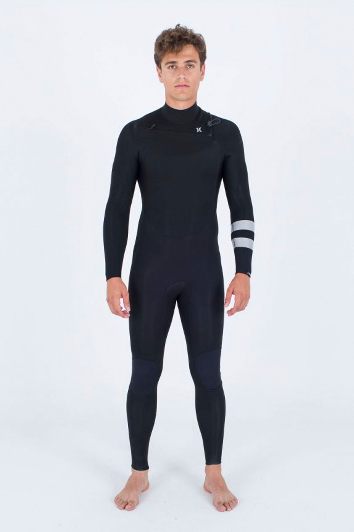 Person wearing a black Hurley Advant 3/2mm wetsuit on a white background