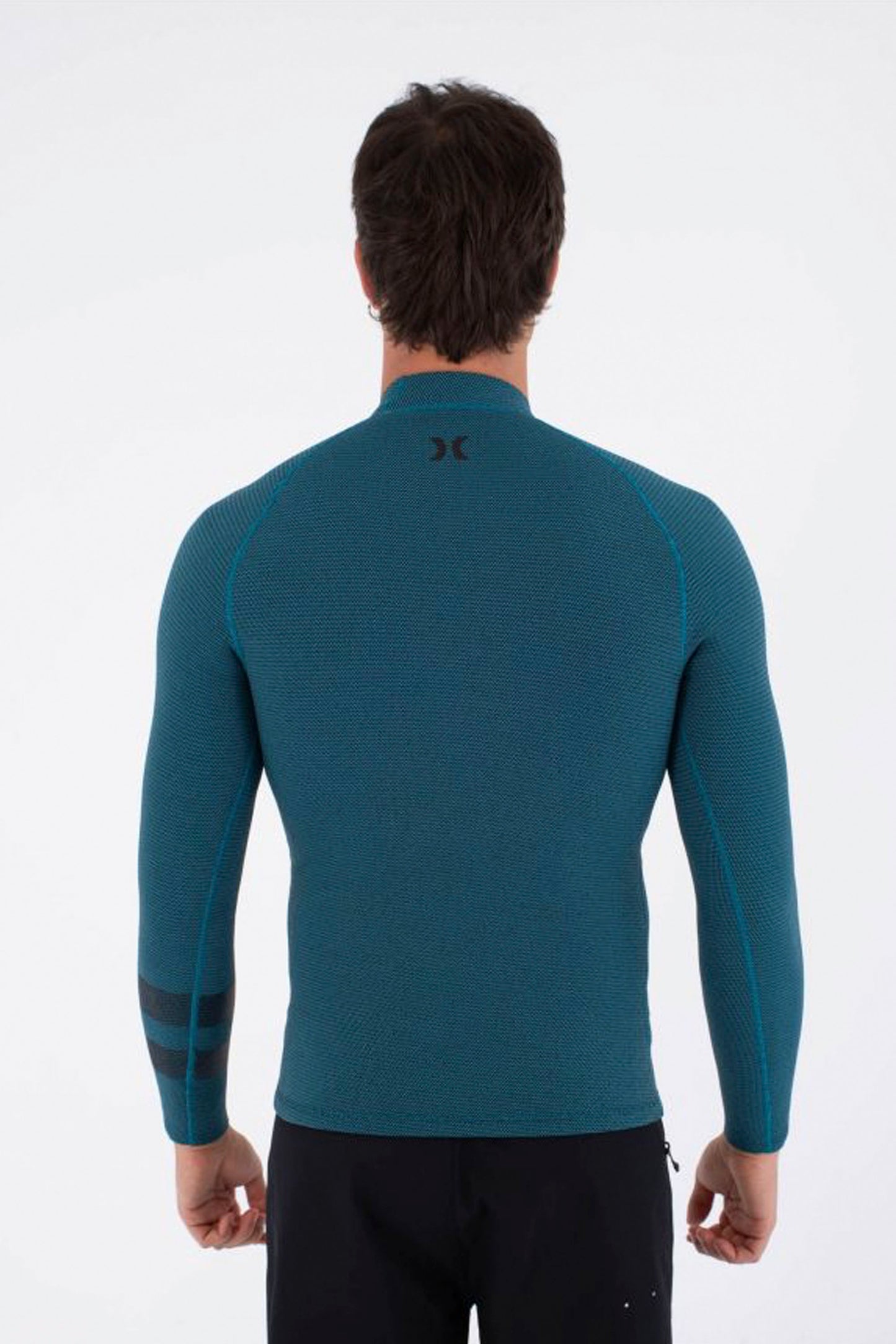 Man wearing a blue long-sleeve Hurley Plus Jacket on a white background