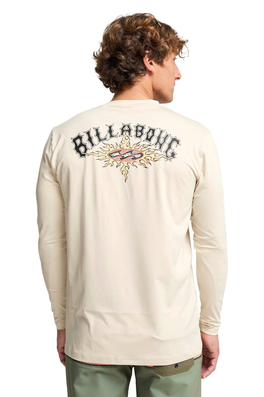 Person wearing a beige long-sleeve shirt with Billabong logo on the back