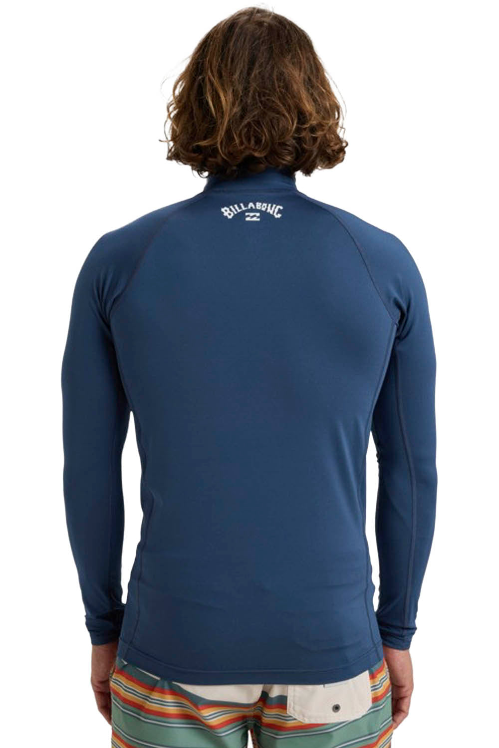 Person wearing a blue Billabong long-sleeve rashguard with a visible logo on the back.
