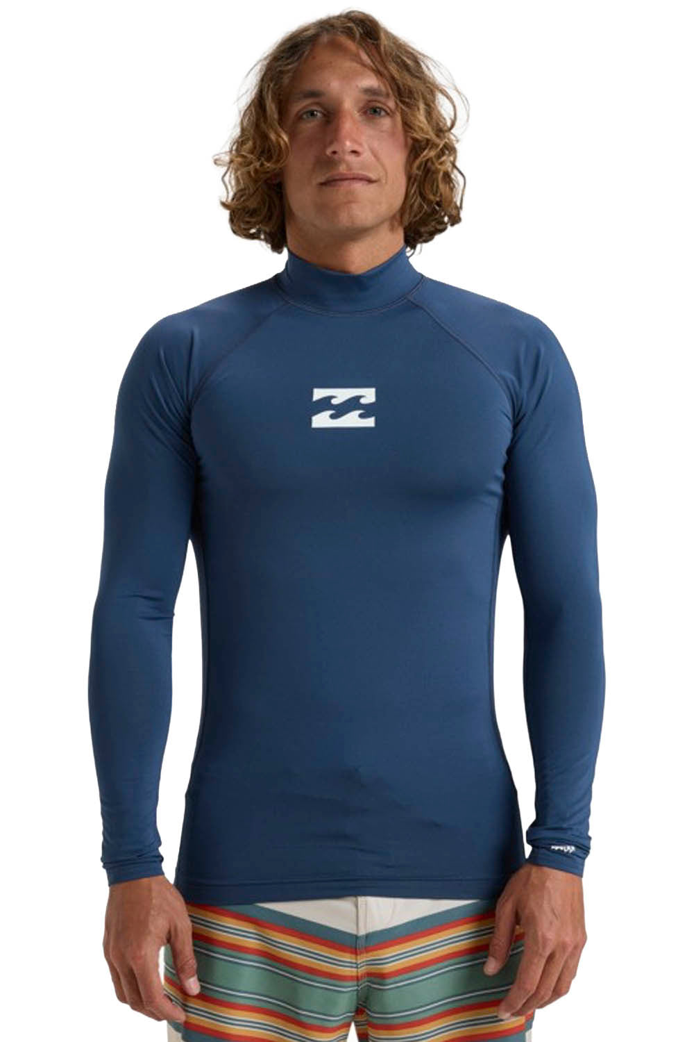 Person wearing a blue Billabong long-sleeve rashguard with a visible logo on the back.