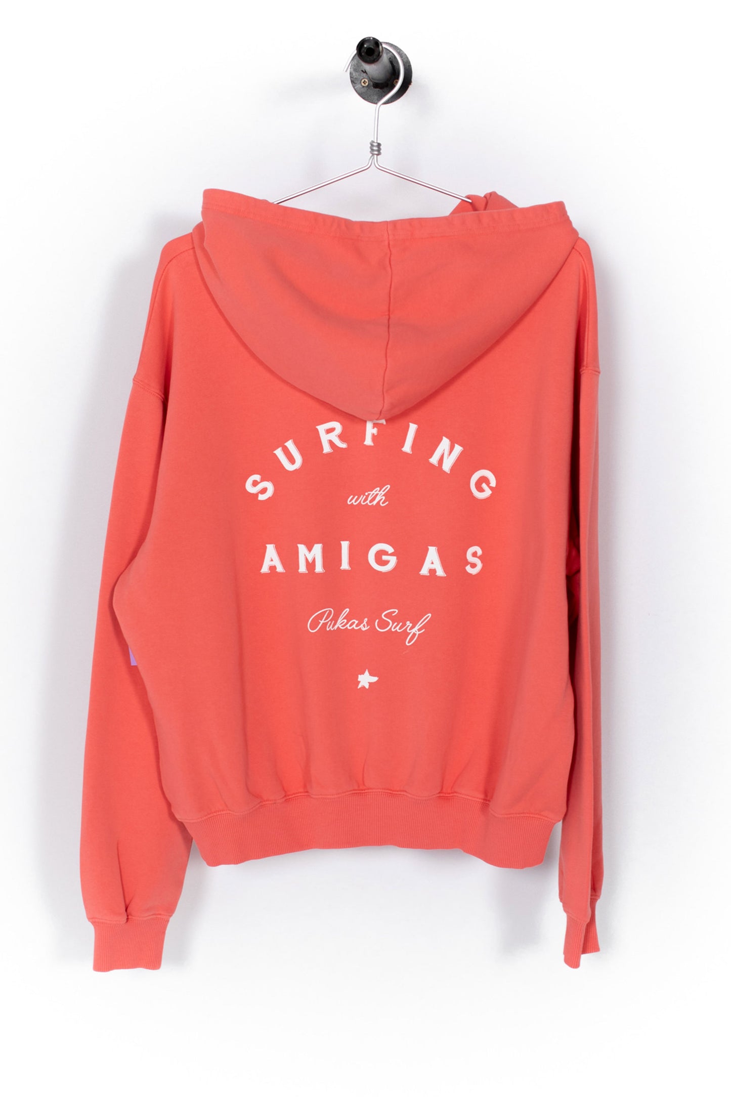 Coral hoodie with 'Surfing with Amigas' text on a white background