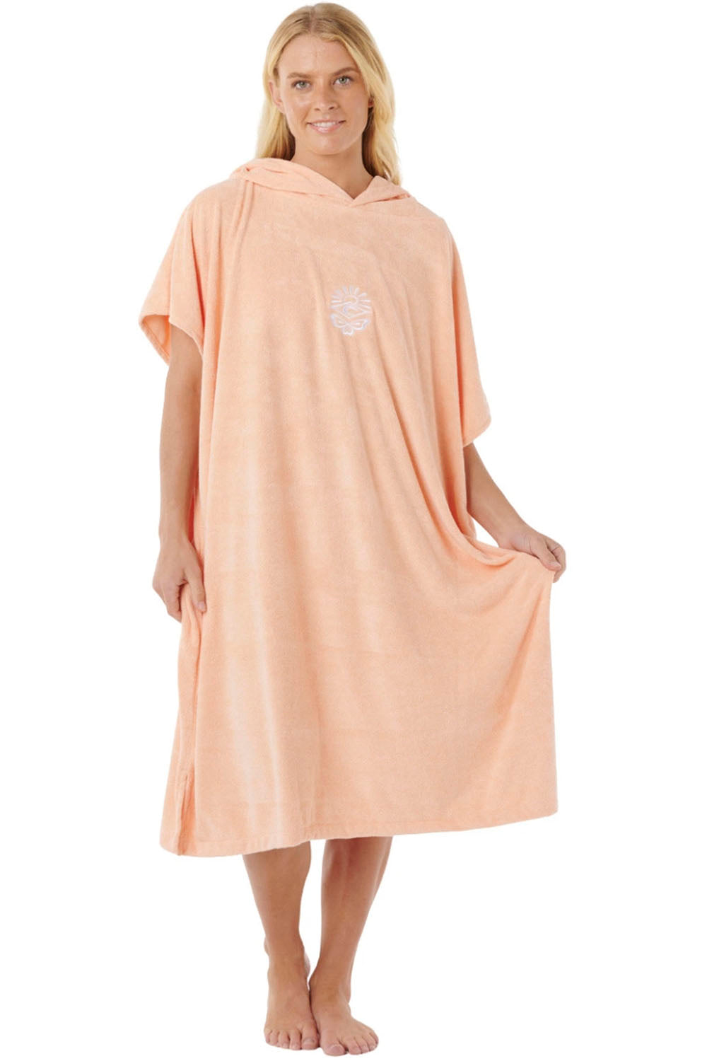 Woman wearing a peach-colored hooded towel on a white background