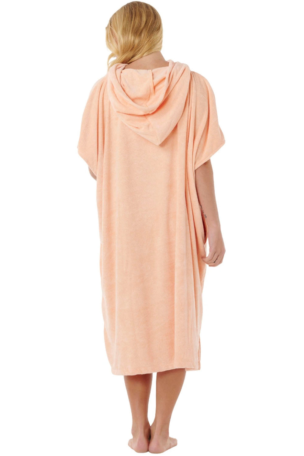 Person wearing a peach-colored hooded dress on a white background