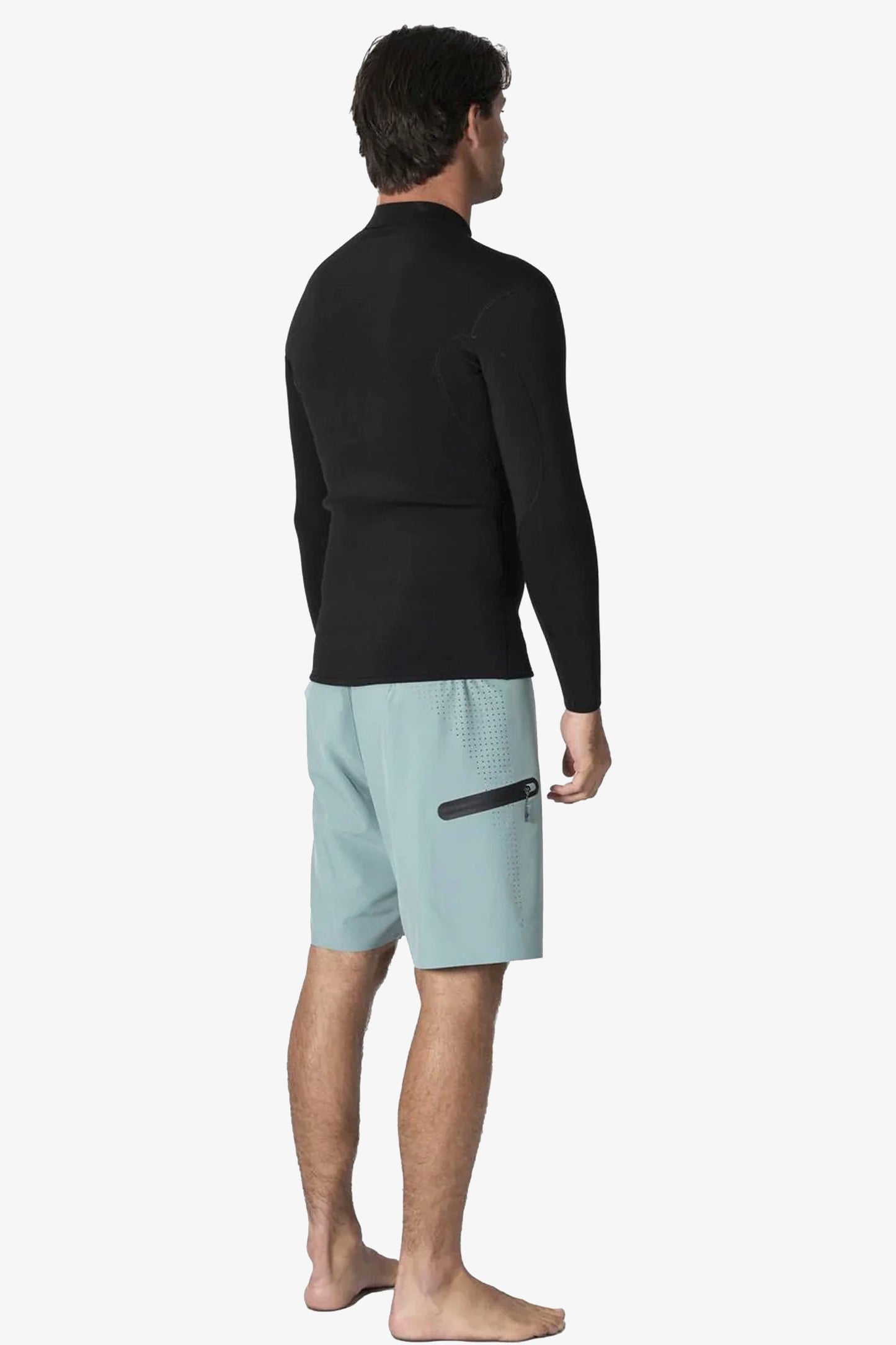 Man wearing a black Vissla wetsuit top Pukas Surf Shop