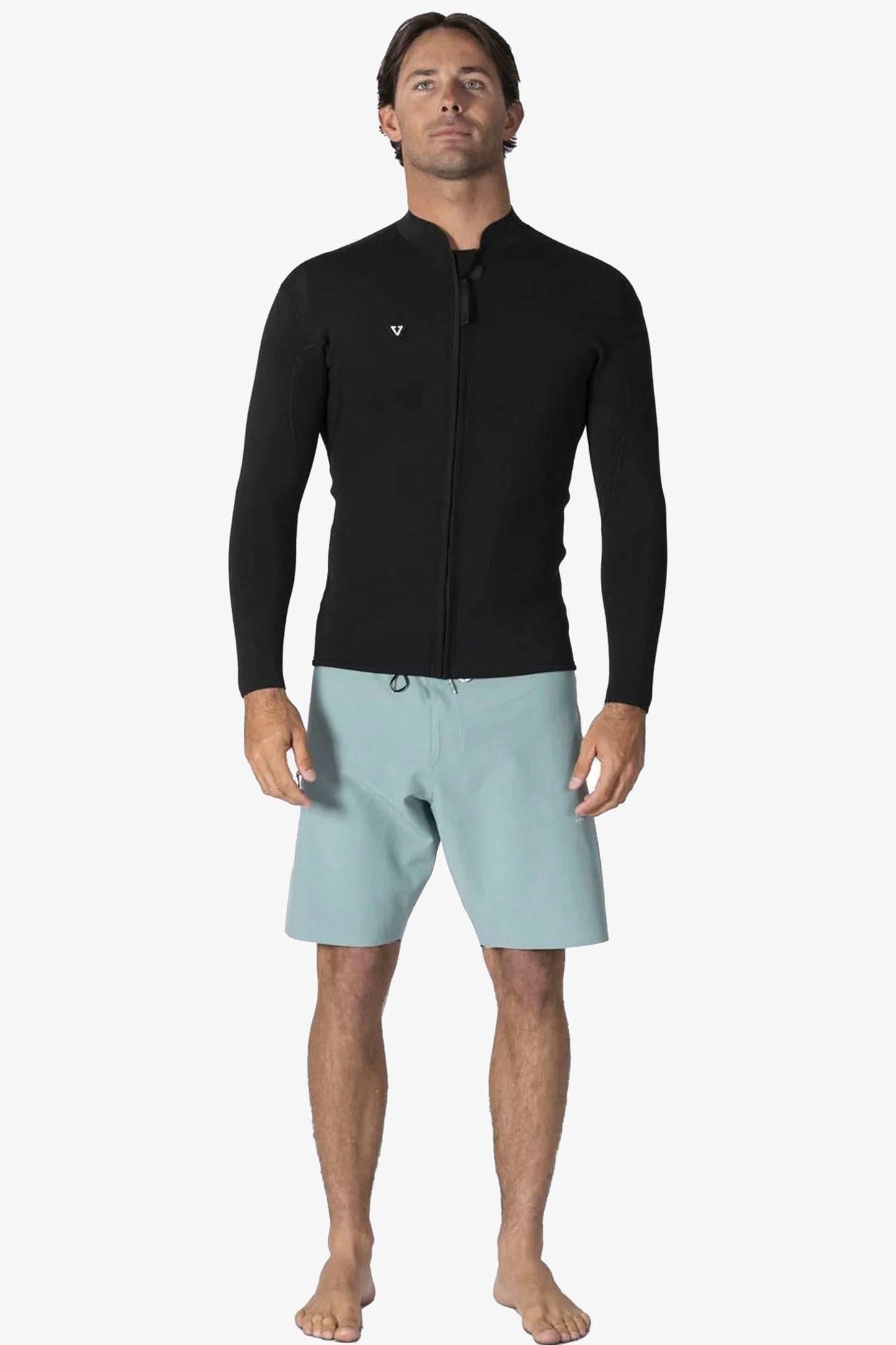 Man wearing a black Vissla wetsuit top Pukas Surf Shop