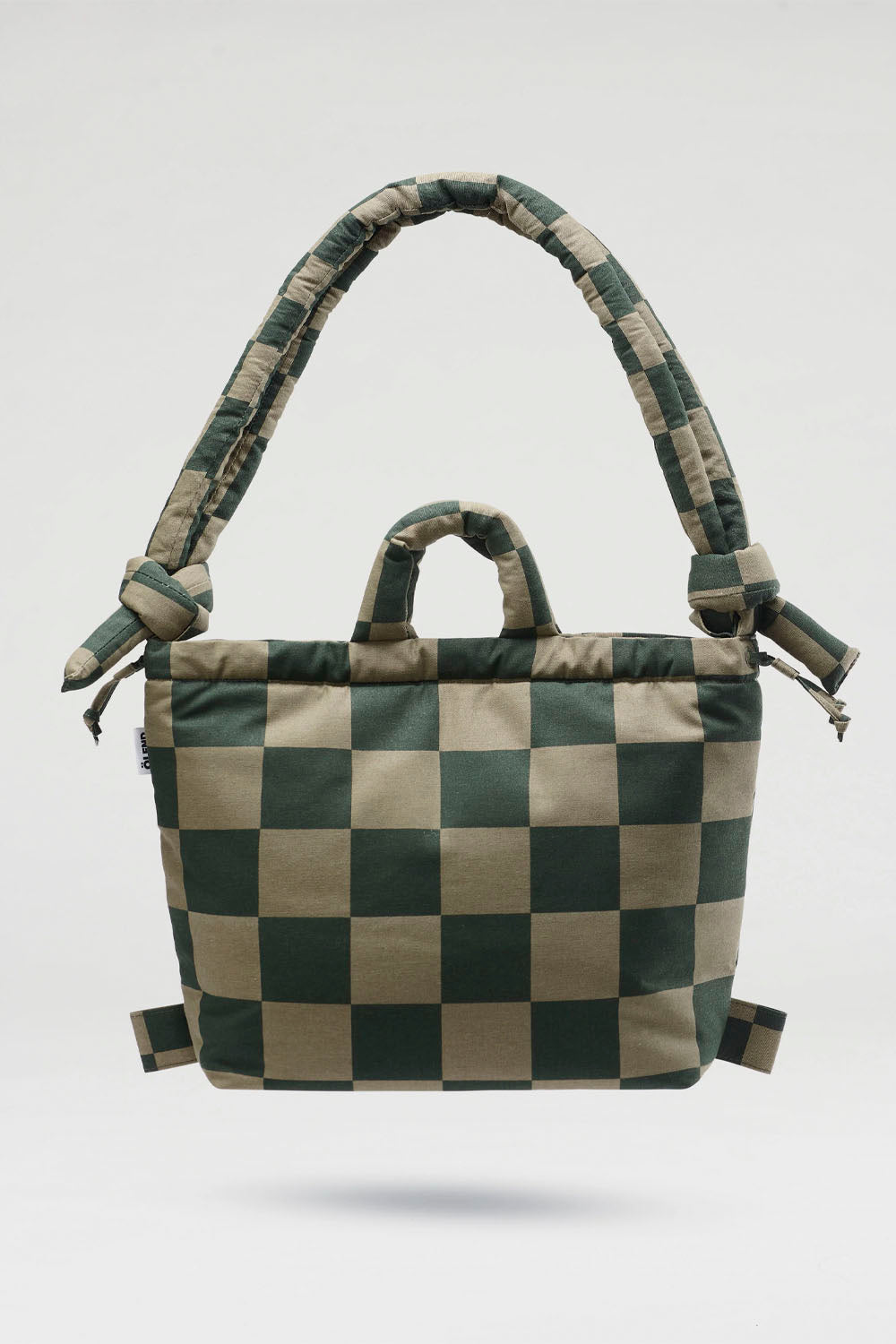 A checkered canvas shoulder bag with a thick padded strap and top handle, shown against a light gray background.