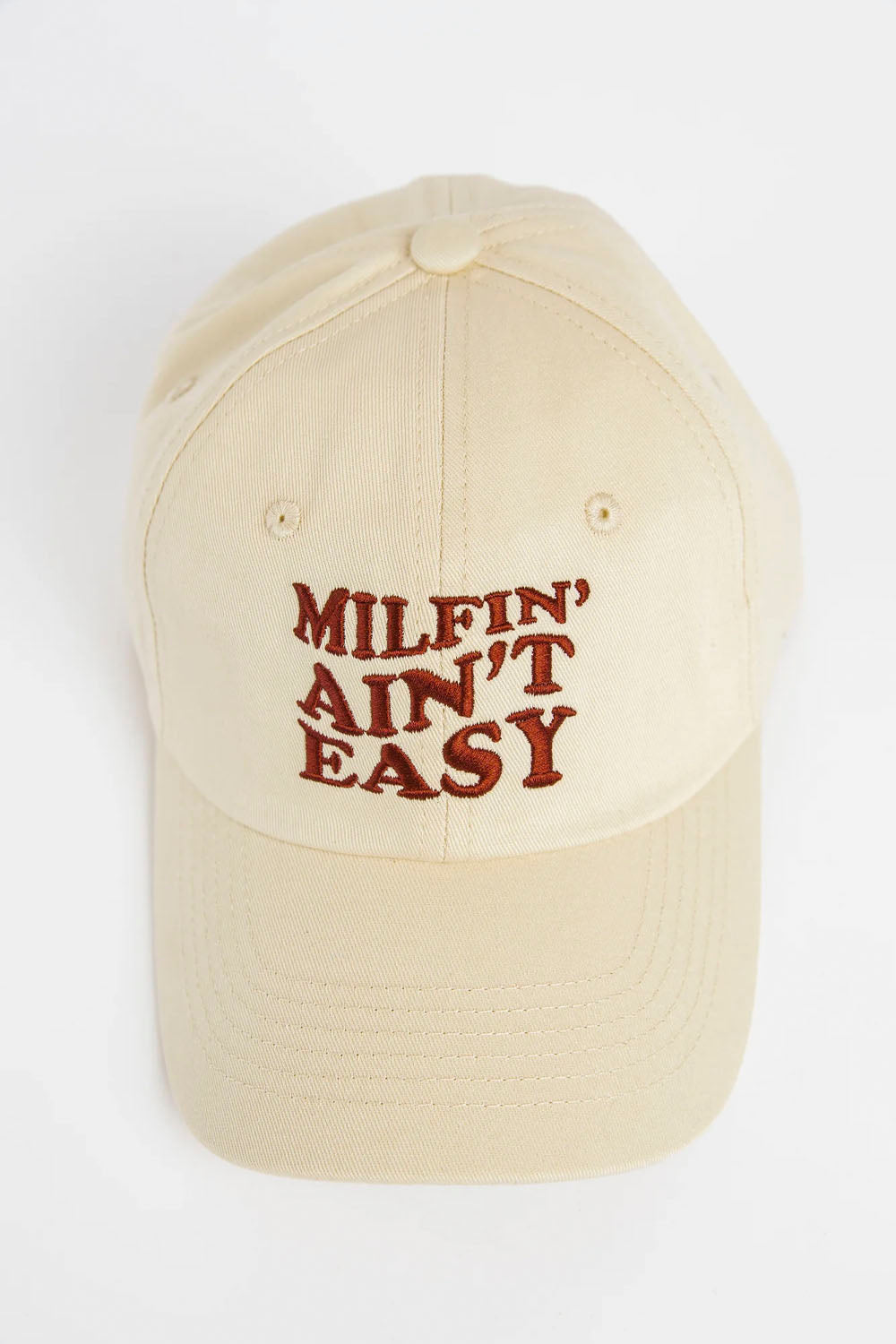 A beige baseball cap with 'MILFIN' AIN'T EASY' embroidered in dark red text on the front, shown against a plain white background.