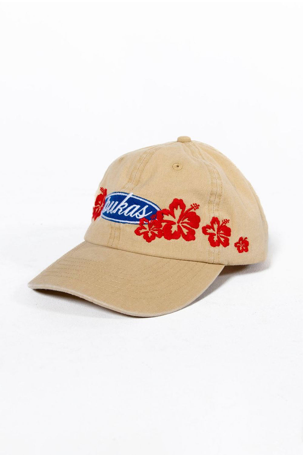 Beige cap with red floral designs and a blue logo on a white background