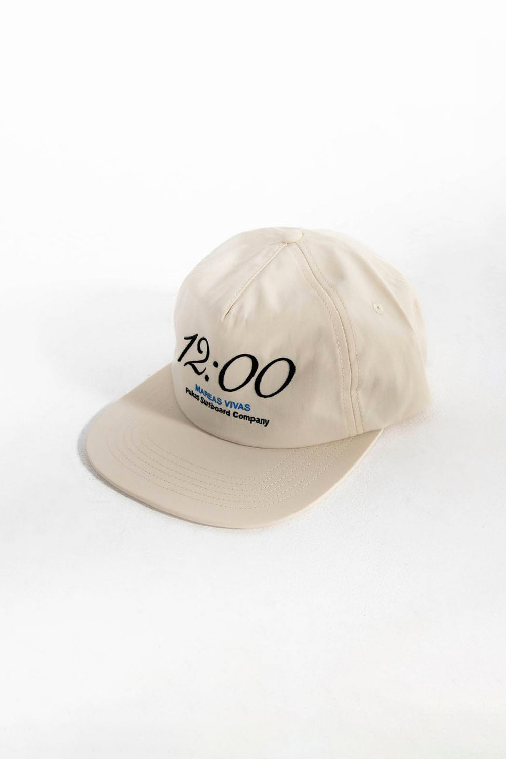 Beige cap with '12:00' and brand name on a white background