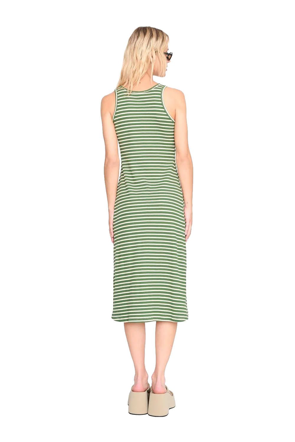 Woman wearing a green striped dress on a white background
