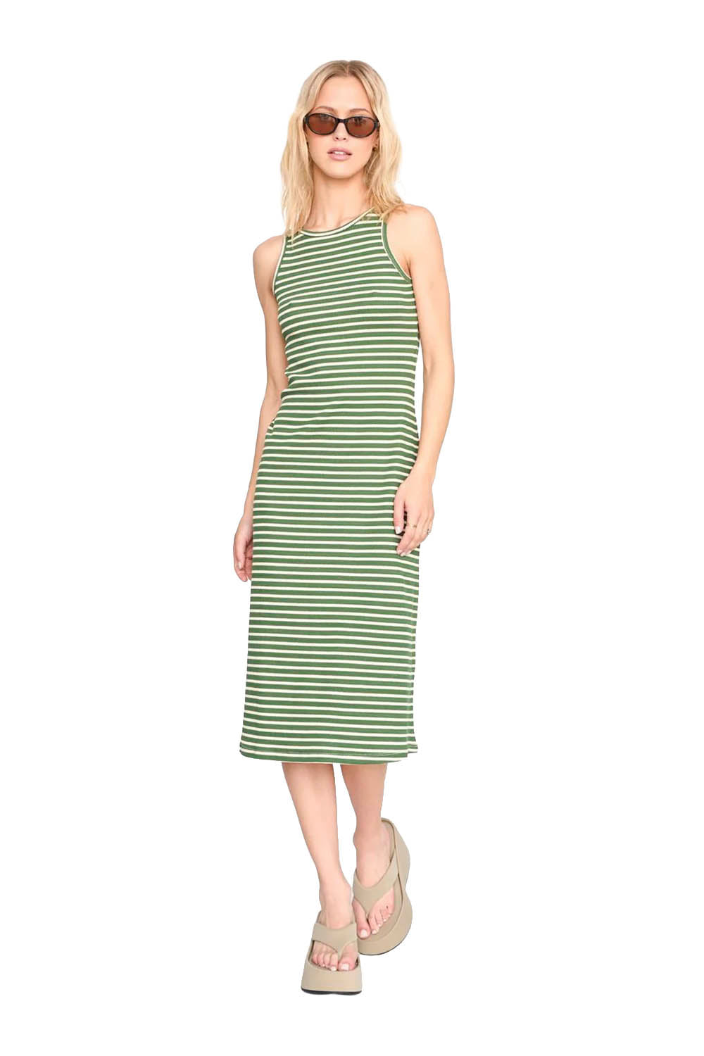 Woman wearing a green and white striped dress on a white background