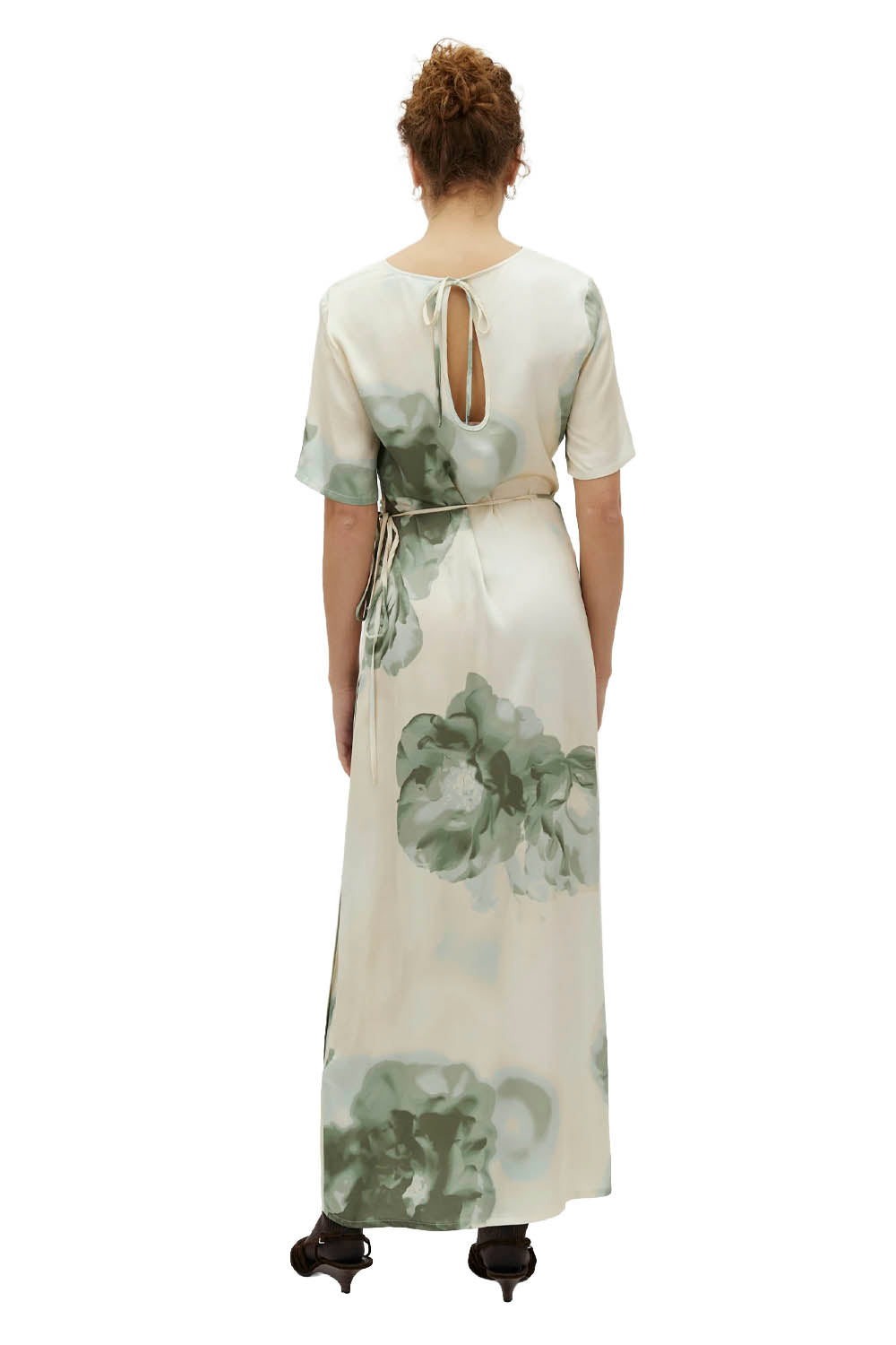 Woman wearing a floral dress with a white background