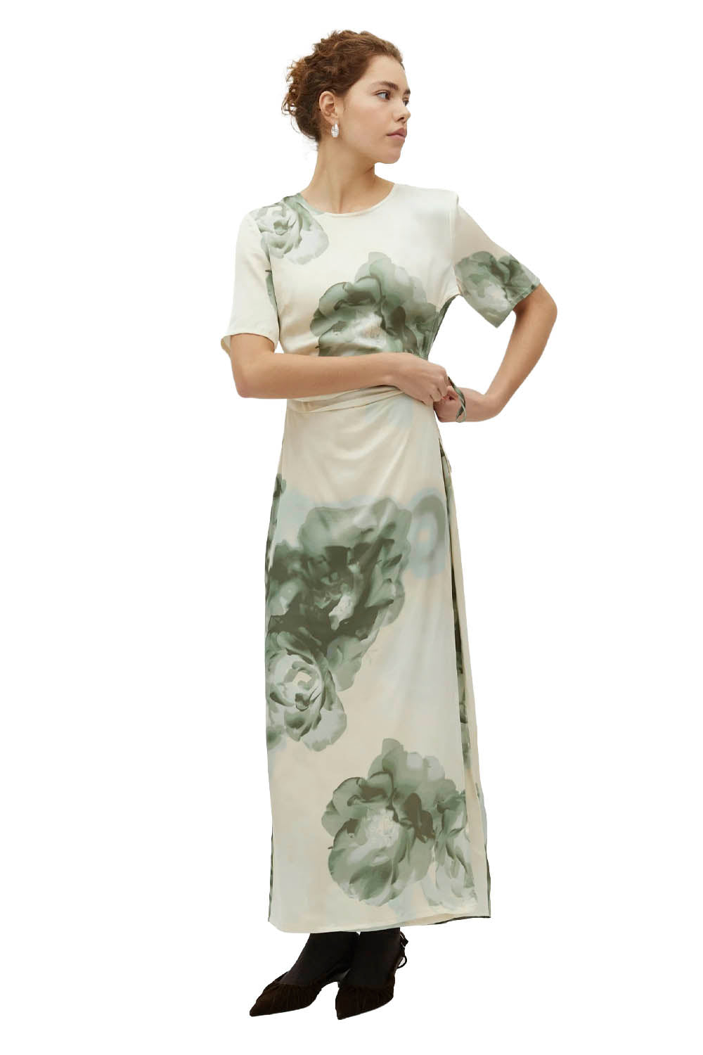 Woman wearing a long dress with floral pattern on a white background