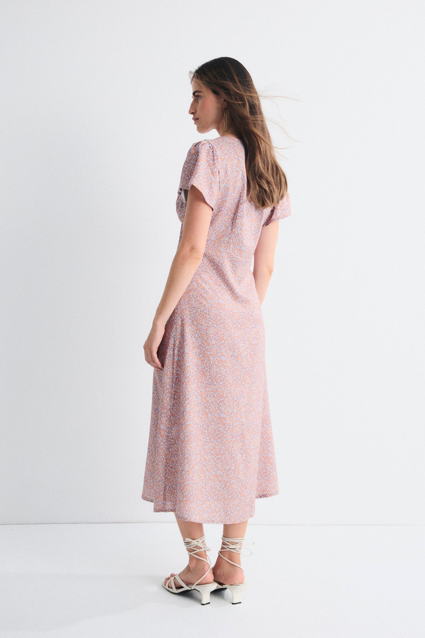 Woman wearing a pink dress on a white background