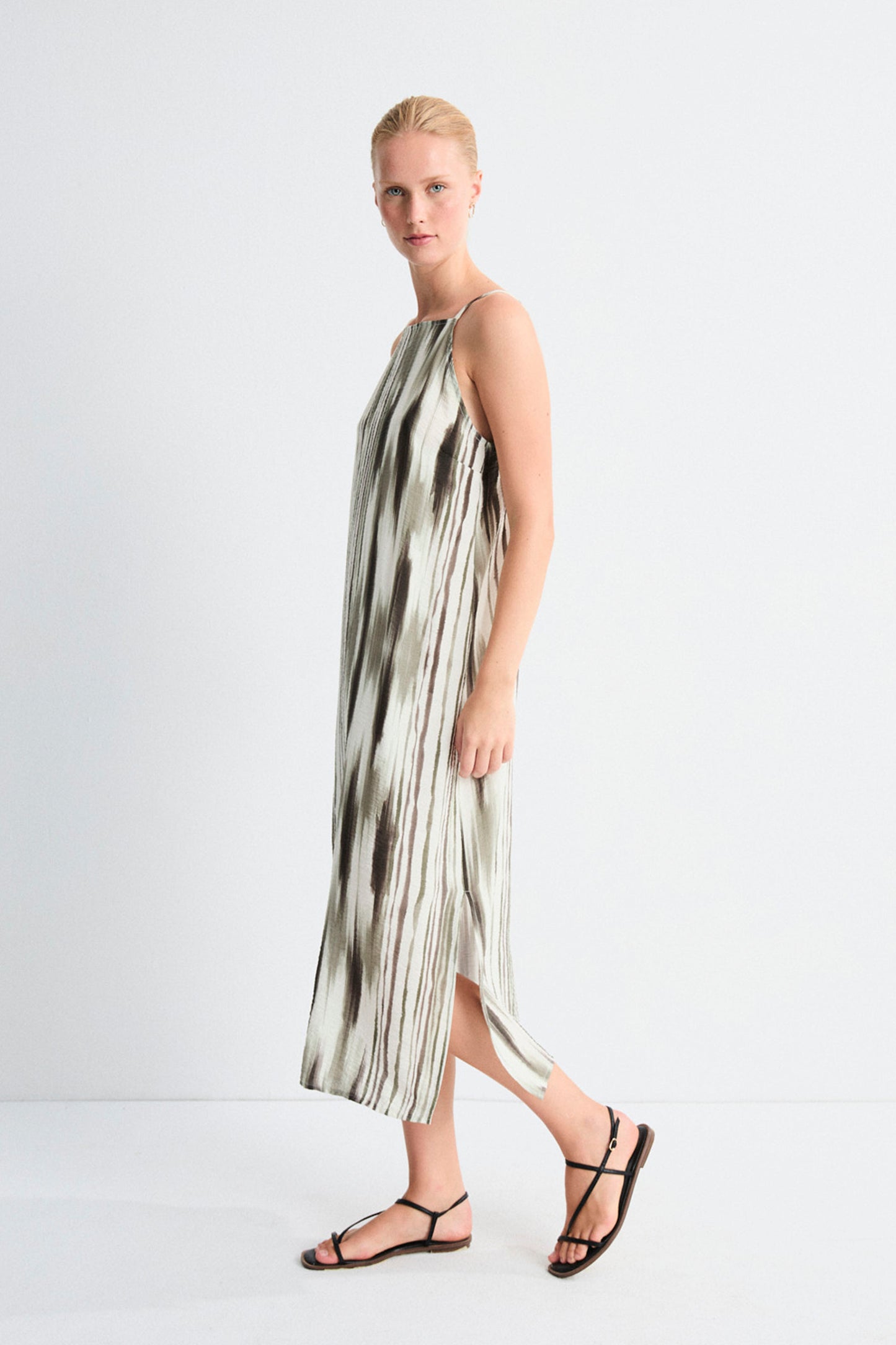 Woman wearing a patterned dress on a white background