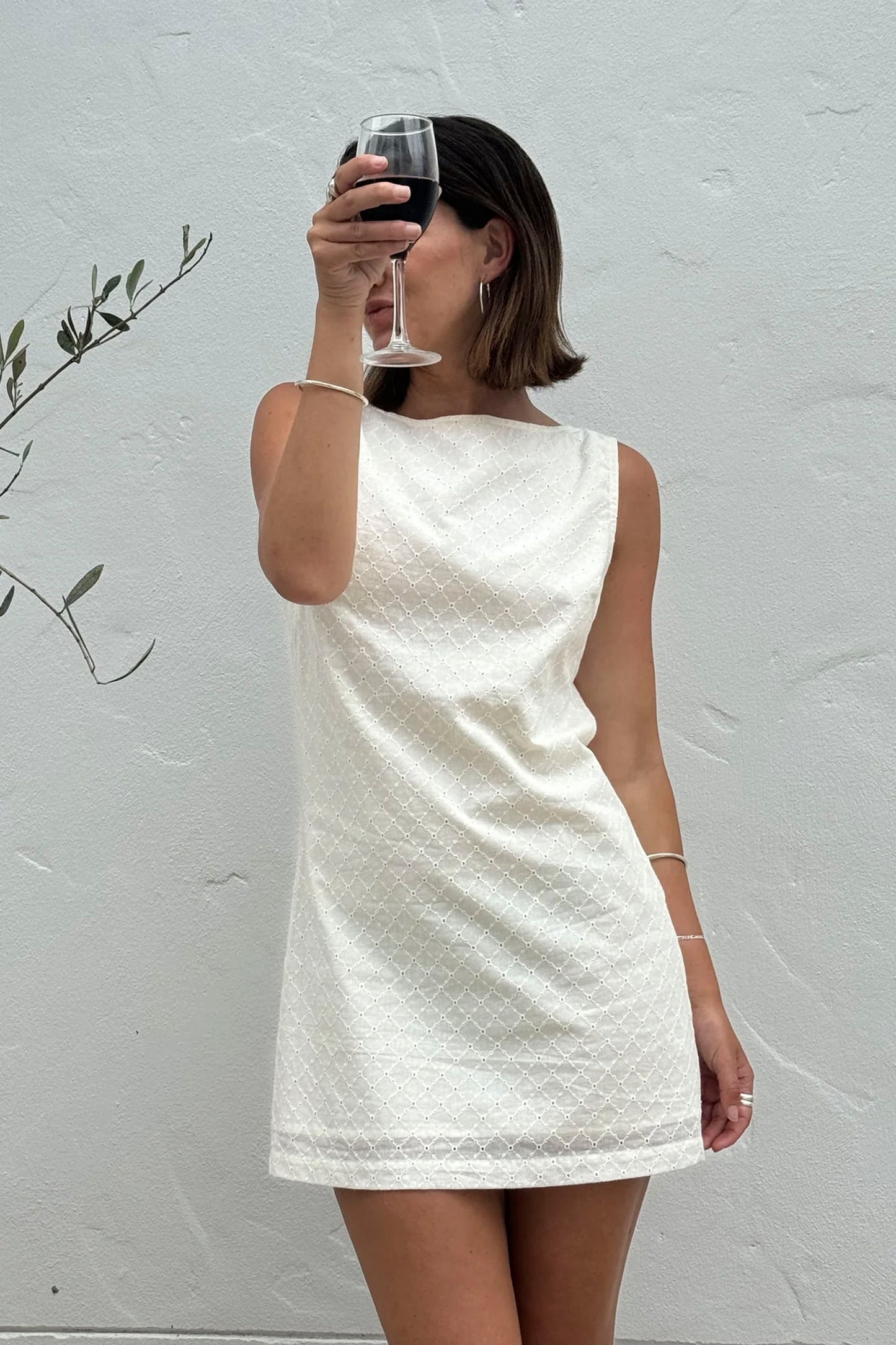 RHYTHM Porto Eyelet Mini Dress in natural featuring delicate eyelet detailing and breezy design