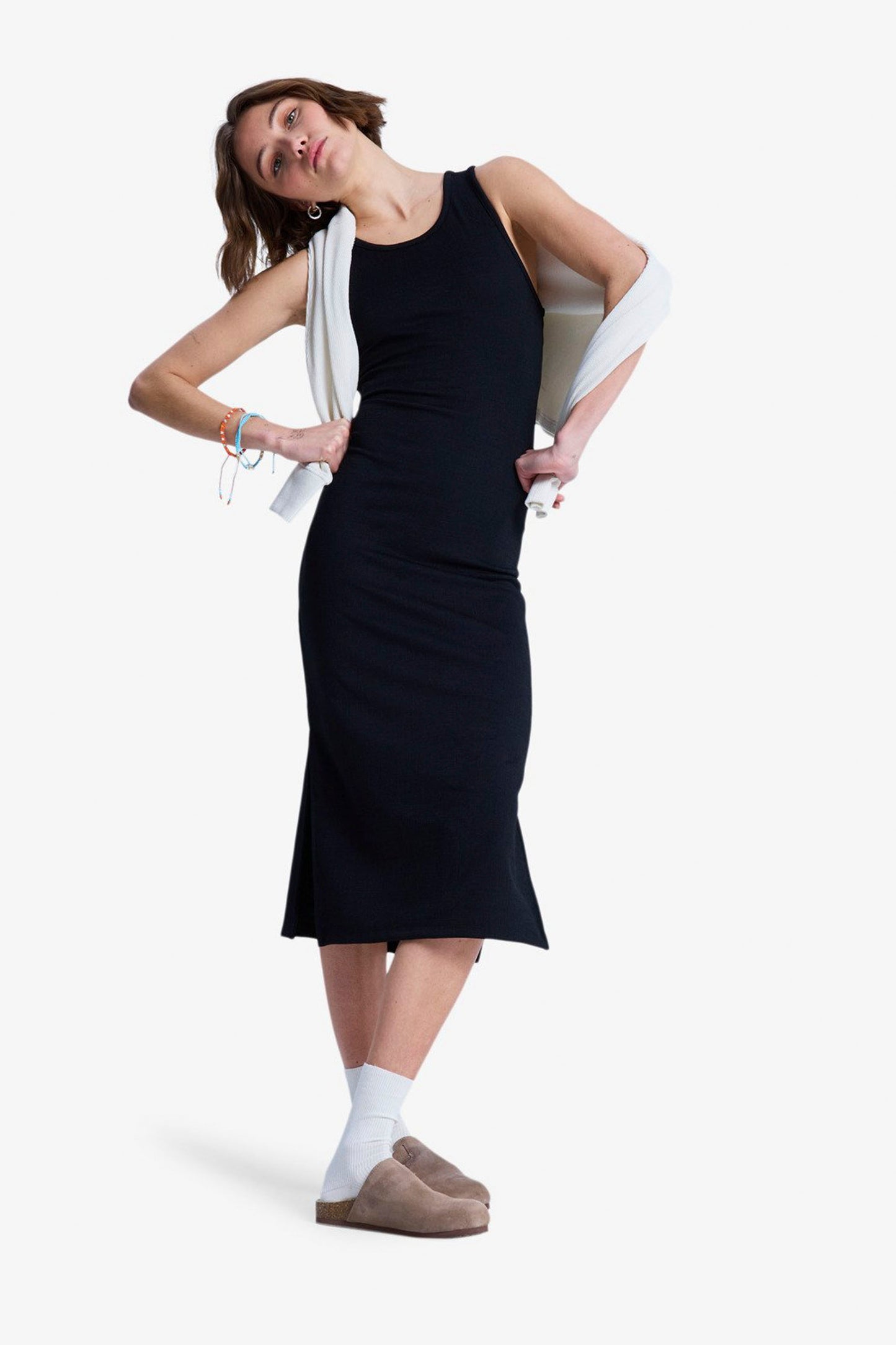 Woman wearing a ROXY Good Keepsake dress with white shoes on a white background
