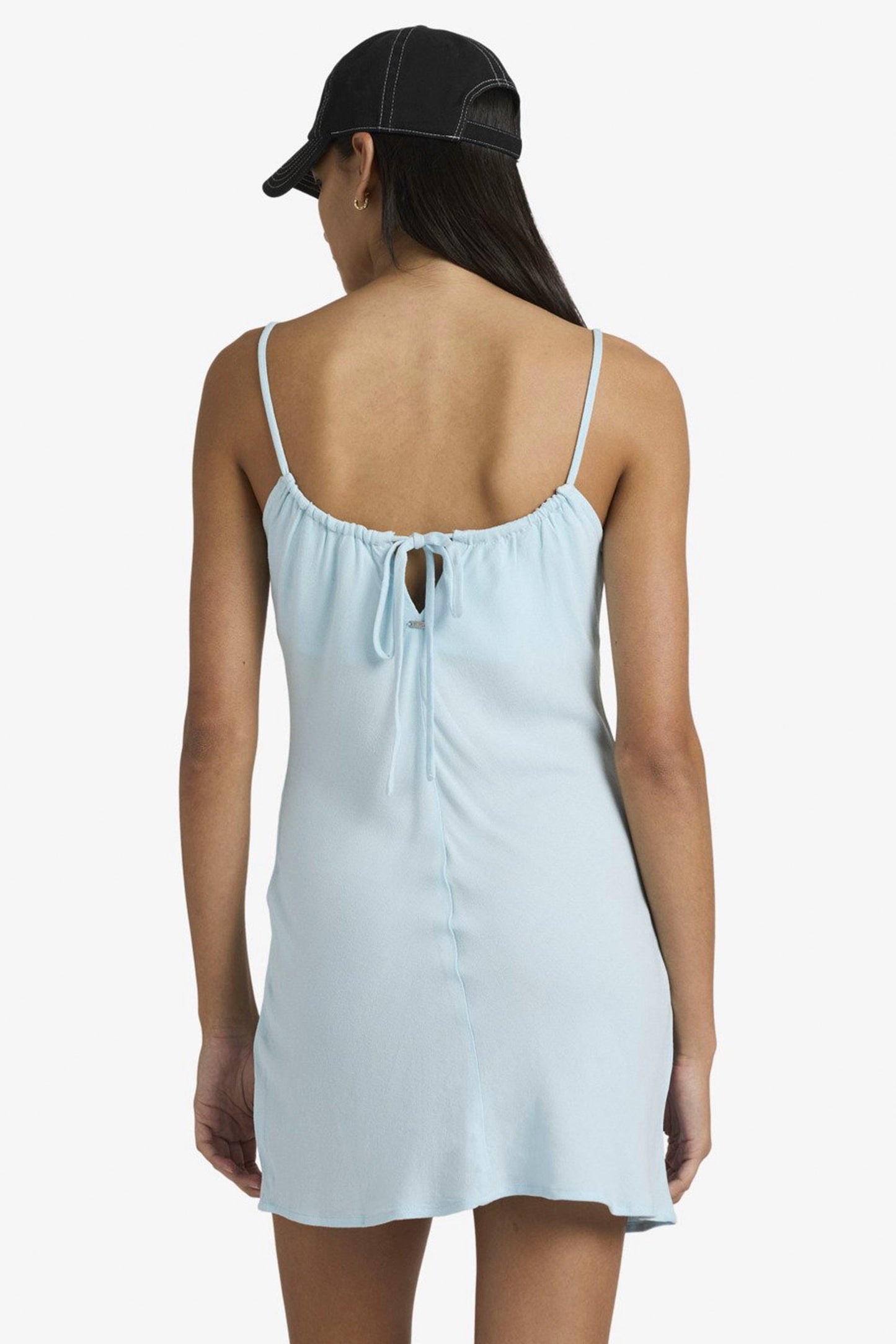 Woman wearing crystal blue Rvca Macarthur mini dress on a white background