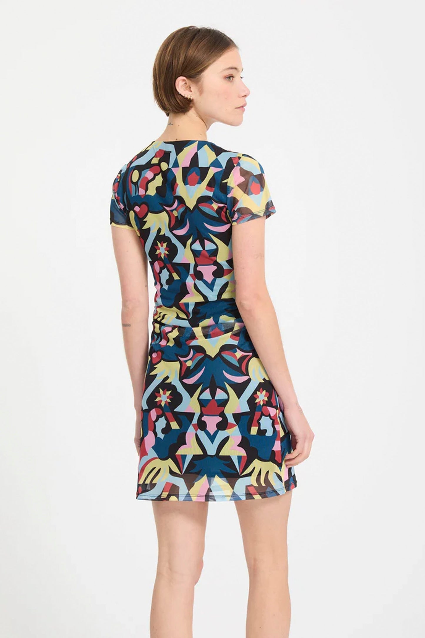 Woman wearing a colorful Volcom Fa Bruno Lucas dress  on a white background