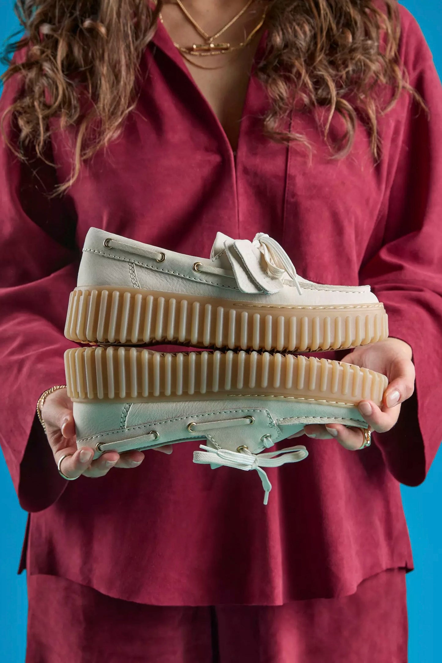 Woman wearing Clarks cream nubuck boat shoes - lifestyle shot showing fit and style