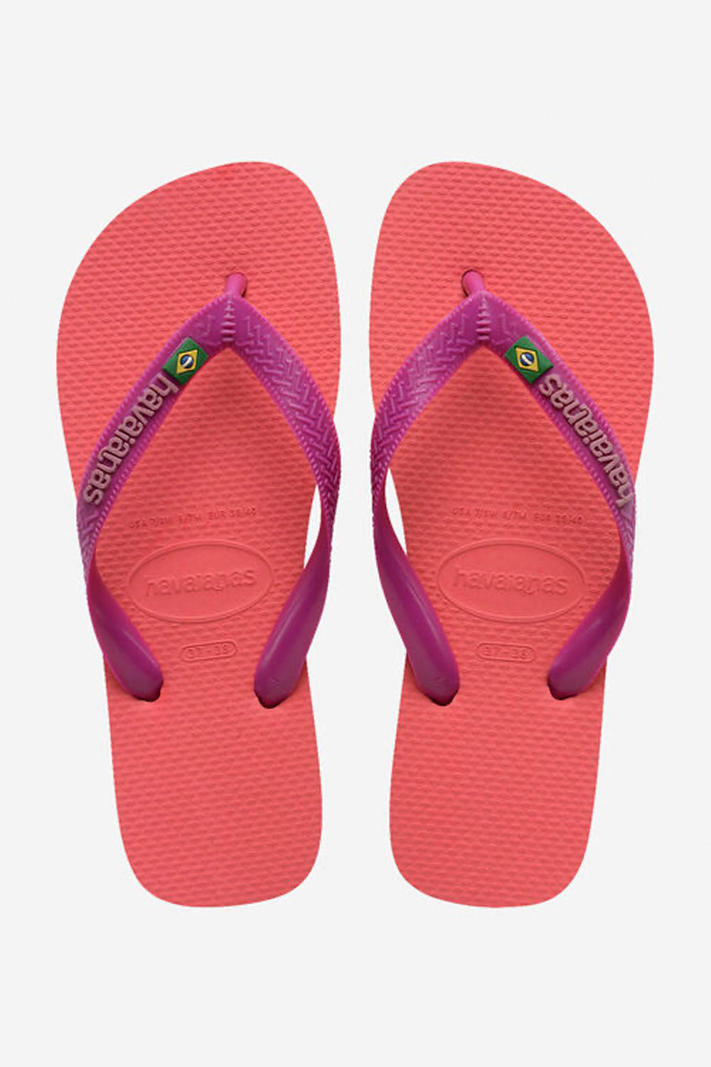 Pair of pink flip-flops with purple straps on a white background
